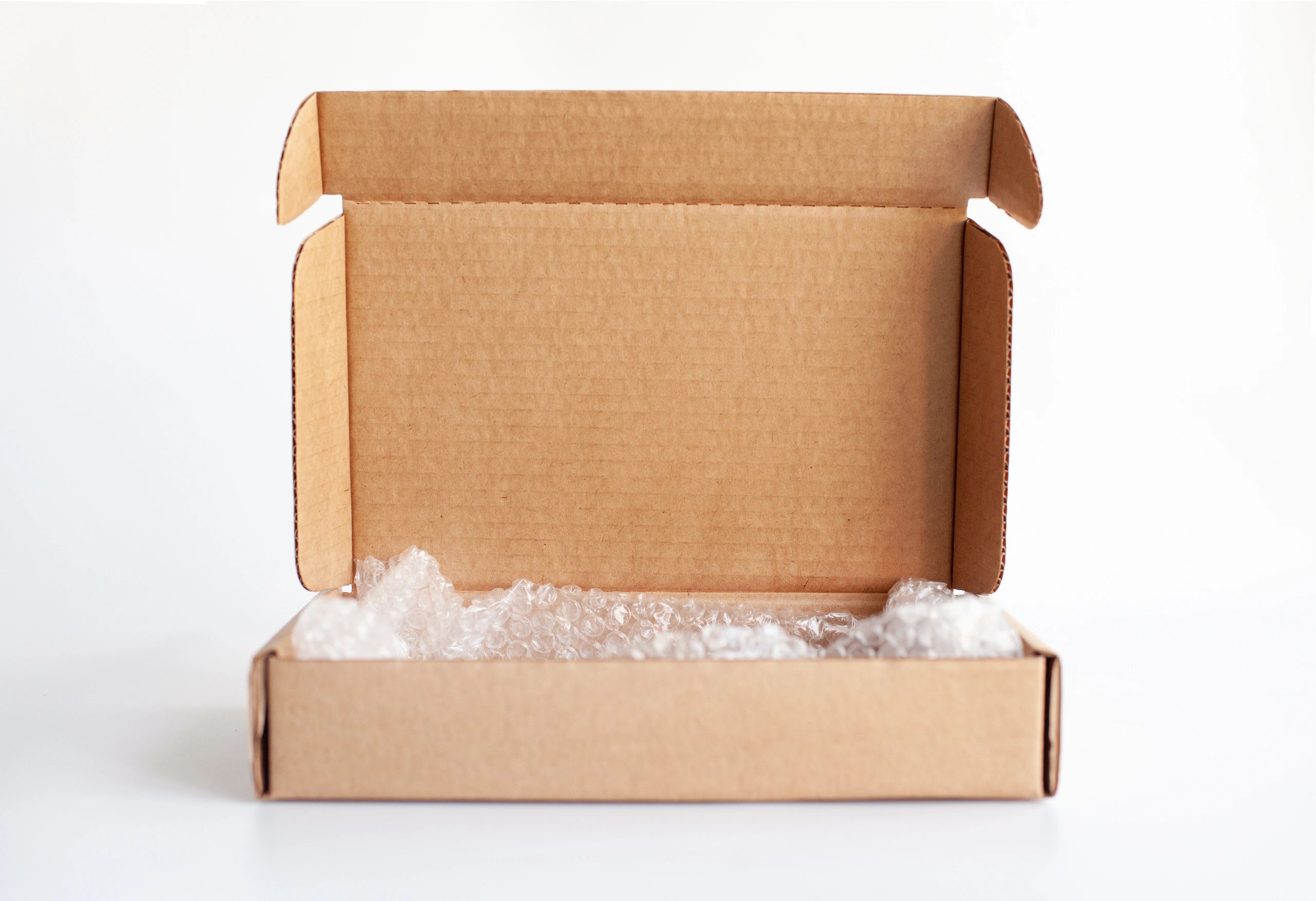 Open cardboard box with packing materials